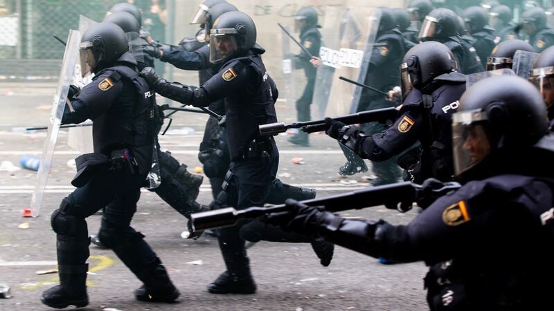 Spanish riot police members prepare to disperse protesters in Barcelona. Photograph: Enric Fontcuberta/EPA