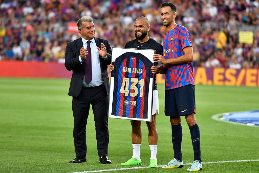 Pumas' Brazilian defender and former Barca star Dani Alves with Barcelona president Joan Laporta and midfielder Sergio Busquets. No club has spent more than Barcelona this summer, despite their debt mountain. Photograph: Pau Barrena/AFP/Getty Images