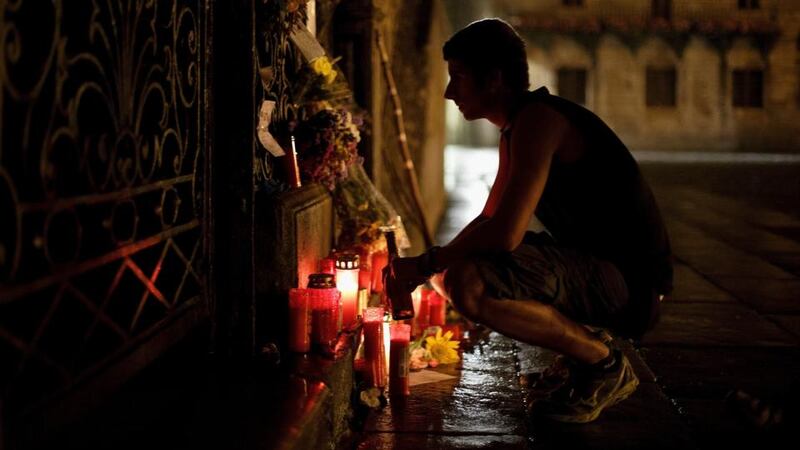 A man reads messages in memory of the train crash victims outside the Cathedral at Plaza do Obradoiro. The high speed train crashed after it derailed on a bend as it approached the north-western Spanish city of Santiago de Compostela  on July 24th. Photograph: Pablo Blazquez Dominguez/Getty Images
