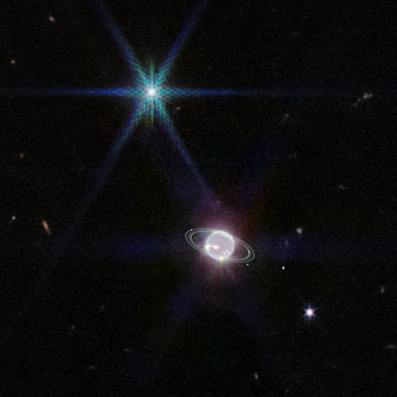 A wider shot of Neptune from the Webb telescope. Triton, Neptune’s largest moon, is the bluish, starlike object at the upper left. Photograph: Nasa, ESA, CSA, STScI via The New York Times