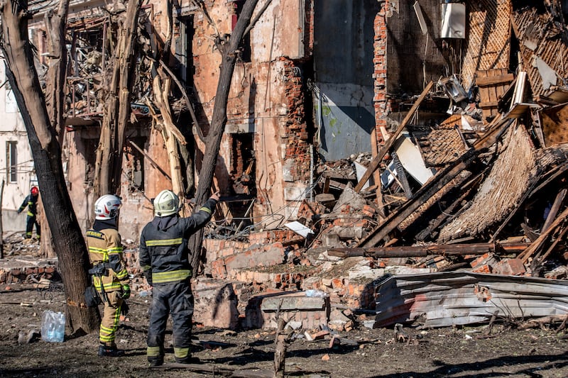 Ukrainian rescuers work by a damaged building in Dnipro. Photograph: Mykola Synelnykov/AFP via Getty Images