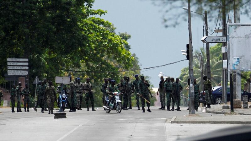 Mutinying soldiers stand next to their camp as they protest over  pay  in the centre of the commercial capital, Abidjan, Ivory Coast. Photograph: Luc Gnago/Reuters
