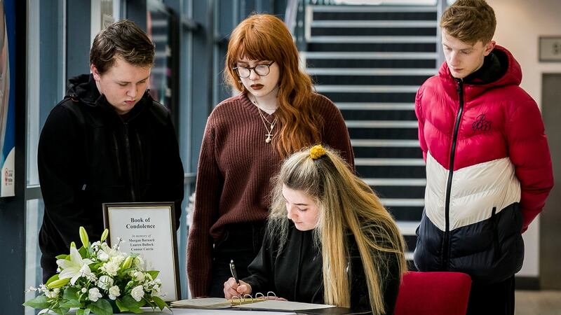Alice Lambert with her fellow performing arts students at South West College Cookstown sign a Book of Condolence in Cookstown. Photograph:  Liam McBurney/PA