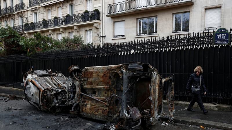Burned-out, upturned  cars  on Avenue Foch on Sunday morning after clashes with protesters wearing yellow vests,  in Paris, France. Photograph: Reuters