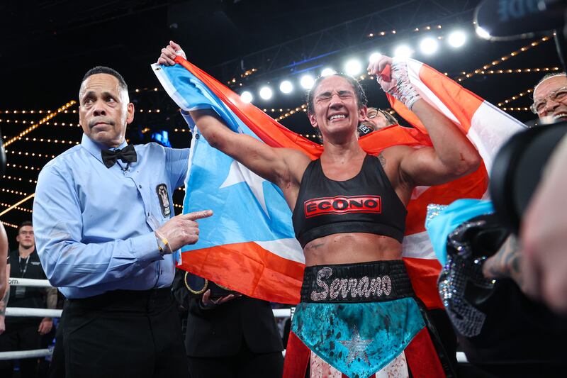 Amanda Serrano, draped in a sky blue Puerto Rican flag. celebrates her victory over Erika Cruz at Madison Square Garden, New York. Photograph: Ed Mulholland/Matchroom Boxing/Inpho
                                                                