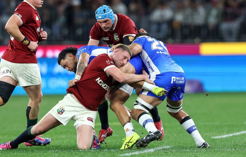 Finn Russell tackles Matty Proctor of Western Force. Photograph: Billy Sitckland/Inpho  