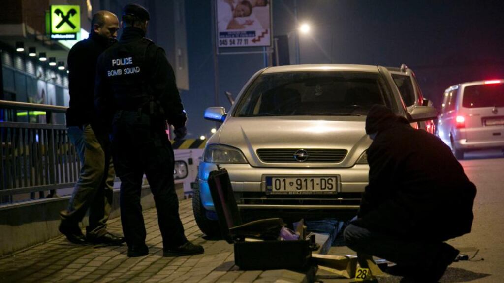 Kosovo police bomb squad and forensic unit members inspect the material found in a car in the capital, Pristina, on Christmas Day. Photograph: Visar Kryeziu/AP Photo