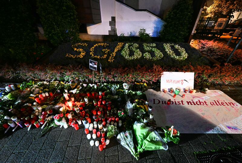 Candles and flowers and the inscription near the area where three people were killed and several injured during a knife attack during a city festival in Solingen in August. Photograph: Ina Fassbender/AFP via Getty Images