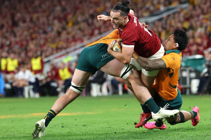 Australia's Jeremy Williams and Len Ikitau tackle James Lowe. Photograph: David Gray/AFP via Getty Images
