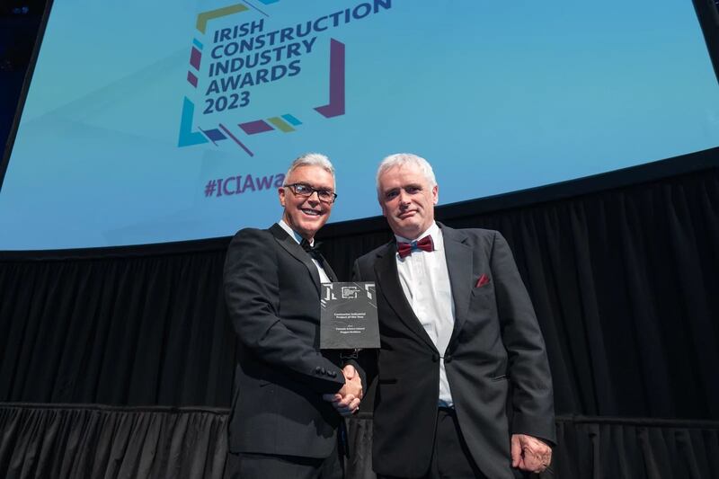 Paul Byrne, associate director at KCC Group, presents the contractor industrial project of the year award to John Butler, Duggan Brothers