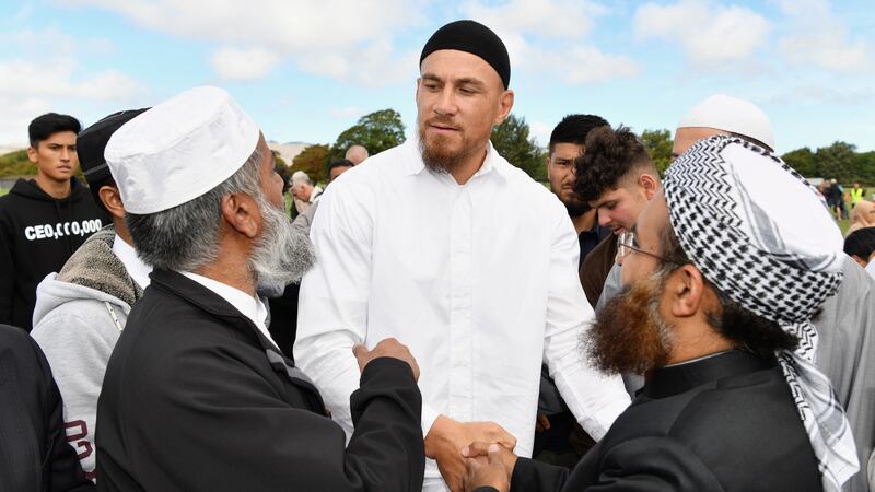 Sonny Bill Williams greets members of the Muslim community after attending Islamic prayers in Hagley Park near Al Noor mosque a week after a gunman killed 50 people and injured dozens more when he opened fire at the Al Noor and Linwood mosques in March 2019. Photograph: Kai Schwoerer/Getty Images