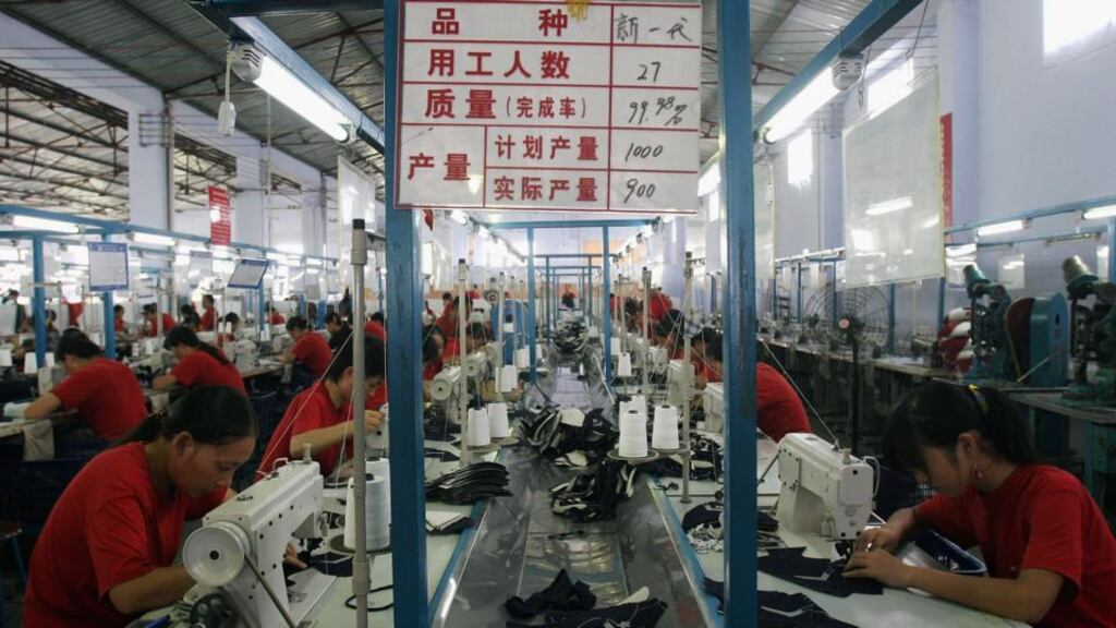 Workers make parts of sports shoes at a shoe factory in Chengdu, Sichuan province, China.