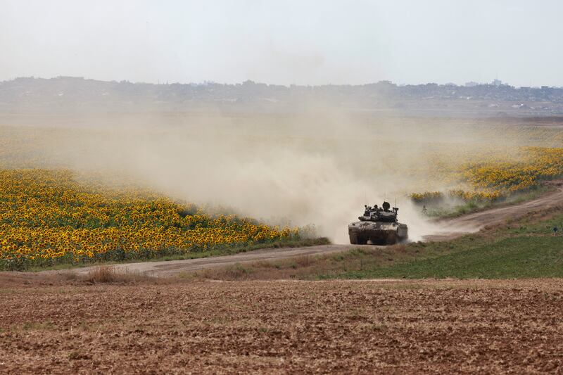 An Israeli army tank rolls near a sunflower field in Israel's southern border with the Gaza Strip. Photograph: Menahem Kahana AFP via Getty Images