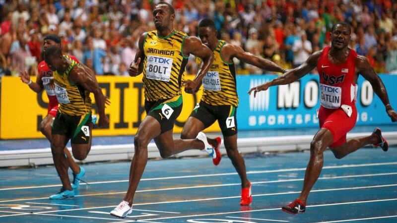 Usain Bolt of Jamaica (centre) crosses the finish line ahead of  Justin Gatlin (right). Photograph: Kai Pfaffenbach/Reuters