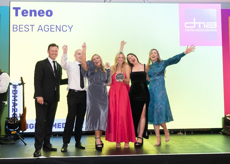 MC Anton Savage presents the award for best agency to Sarah Murphy and members of the team from Teneo. Photograph: Paul Sherwood