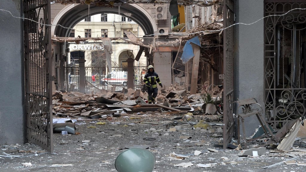 A firefighter walks among debris after Russian shelling in Kharkiv. Photograph: Sergey Bobok/AFP via Getty Images