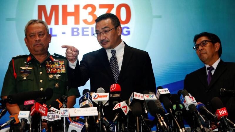 Malaysia’s acting transport minister Hishammuddin  Hussein answers questions at a media briefing today, in  between Chief of the Armed Forces Gen Zulkifeli Mohd Zin (left) and the Malaysian Department of Civil Aviation’s director general Azharuddin Abdul Rahmanthe on the missing Malaysia Airlines MH370 jet. Photograph: Edgar Su/Reuters