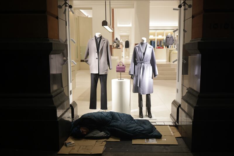 A homeless man sleeps in the predawn hours on Grafton Street in Dublin. Photograph: Chris Maddaloni
