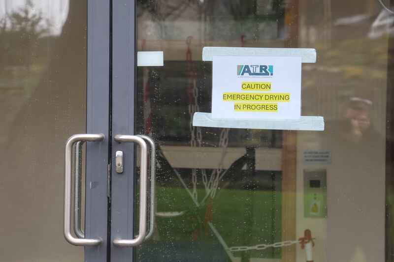 A sign on a ground-floor apartment in Aikens Village, Stepaside, where dehumidifying is still taking place two weeks after Storm Chandra