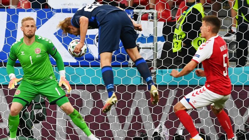 Finland’s  Joel Pohjanpalo heads home the opening goal past Denmark goalkeeper Kasper Schmeichel at the Parken Stadium in Copenhagen. Photograph: Stuart Franklin/EPA