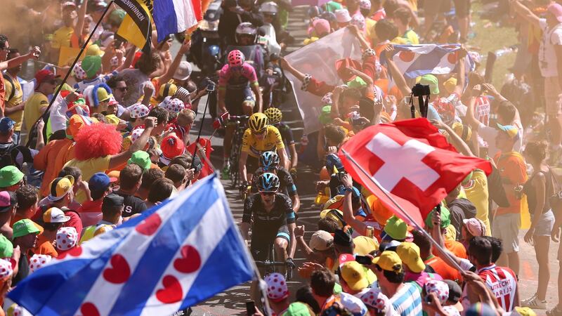Yellow jersey holder Chris Froome, Richie Porter, Poels Wout and Alejandro Valverde ride through the crowds on Alpe d’Huez. Photograph:  Tim de Waele/Corbis via Getty Images