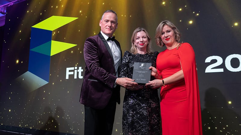 Tom Mockler, sales director at Tarkett, presents the fit out project of the year - medium office award to Alison Ahern and Lisa Smyth, Reddy A+U