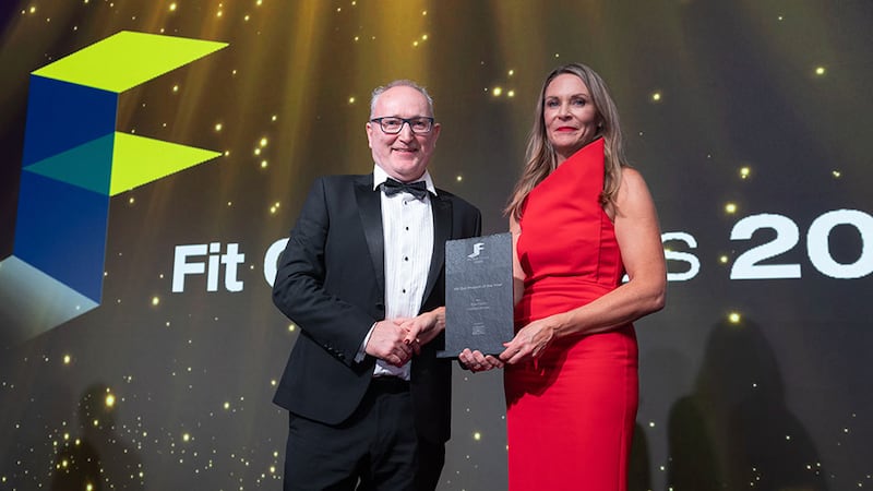 Cathal McGuinness, director at SAS International, presents the fit out project of the year award to Joanne Reilly, Total Fitout