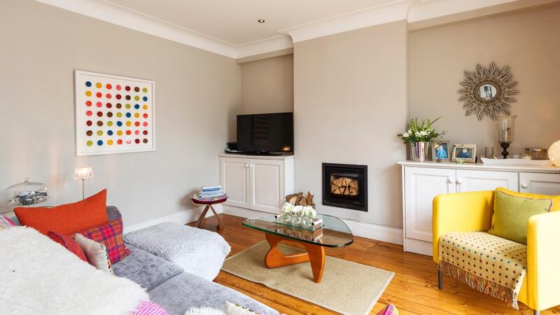 What was the formal dining room at 18 Springfield Road has been turned into a more informal  living space, warmed by a wood-burning stove.