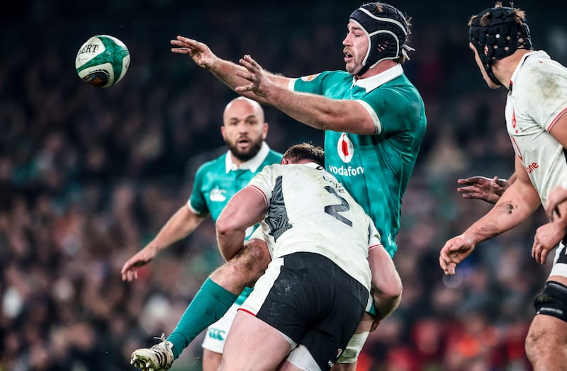 Ireland captain Caelan Doris offloads as he is tackled by Wales' Dewi Lake. Photograph: Nick Elliott/Inpho