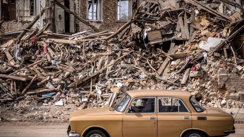 A man drives a car past the rubble of a destroyed building in the eastern Ukraine city of Kharkiv. Photograph: Fadel Senna/AFP via Getty Images