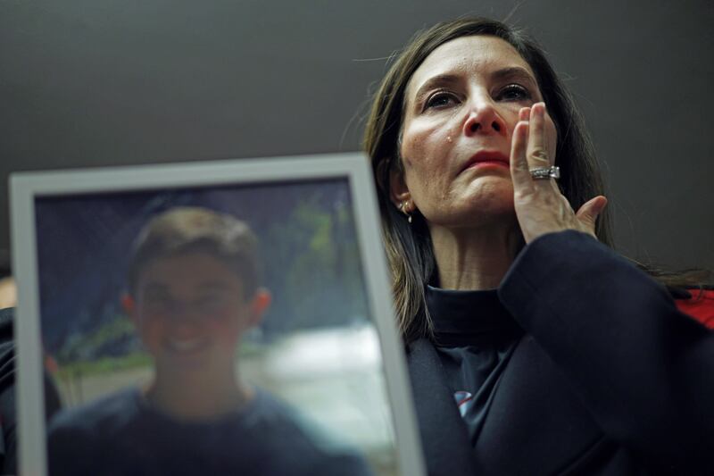 Rose Bronstein of Chicago, Illinois, wipes tears as she holds a picture of her son Nate, who took his own life in 2022 after being cyberbullied, during a news briefing after Wednesday's hearing before the US Senate Judiciary Committee. Photograph: Alex Wong/Getty Images