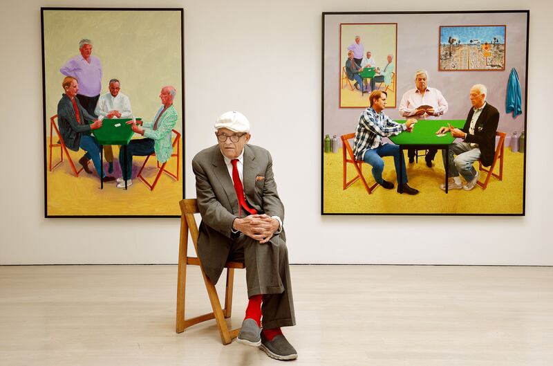 David Hockney with his works Card Players and A Bigger Card Players. Photograph: John Stillwell/PA