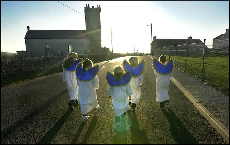 Schoolchildren from Killaghtee National School, Donegal, walk to the church to rehearse for the school's nativity play, in December 2001. Photograph: Brenda Fitzsimons