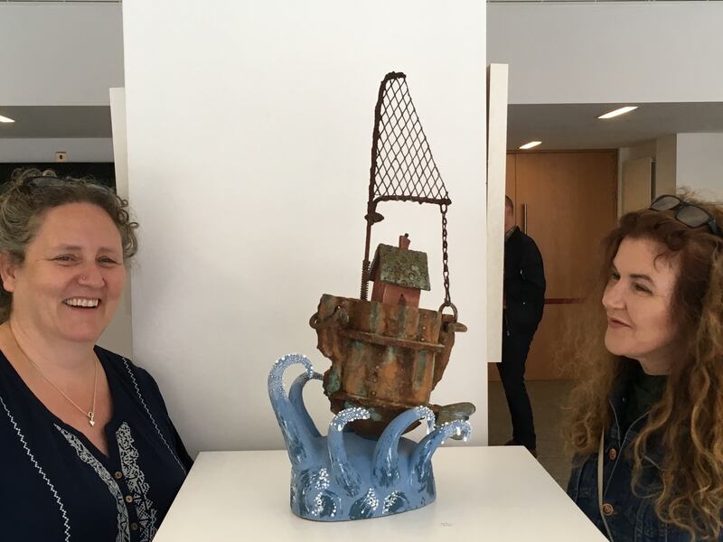 Tina Byrne of Ceramics Ireland and architect and designer Roisin Murphy examine a work by John Quinn, at the Clay Works exhibition at Dublin Castle, which runs until August 31st