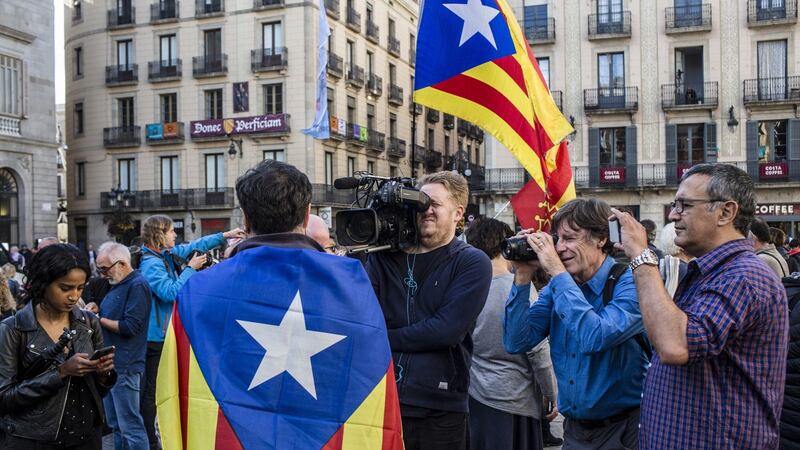 Television crews interview a Catalan independence supporter outside the regional government offices in Barcelona on Monday. Photograph: Angel Garcia/Bloomberg