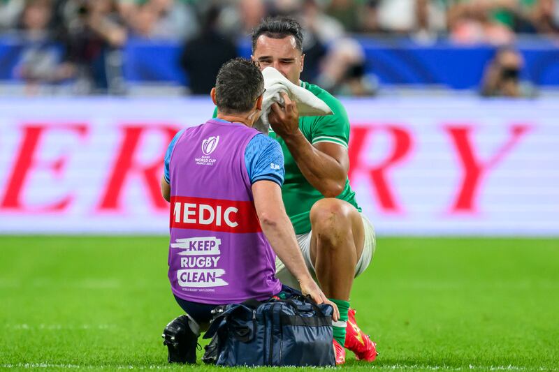James Lowe has his eye injury looked at by Ireland physio Stephen Mutch. Photograph: Craig Watson/Inpho 