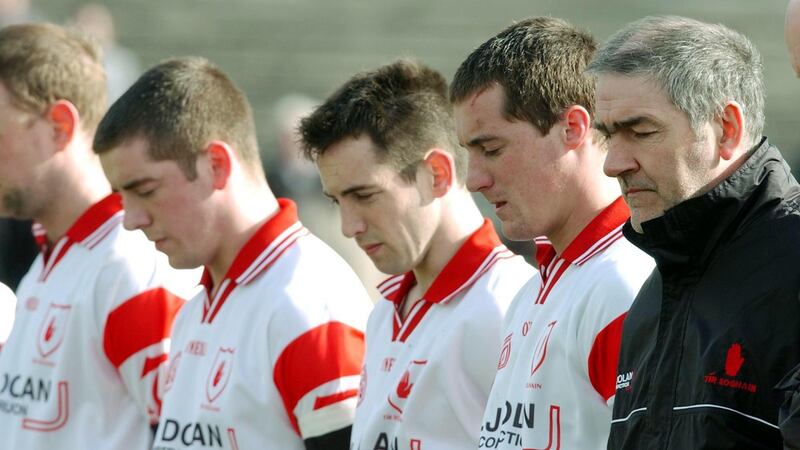 Tyrone players and manager Mickey Harte observe a minute’s silence  in memory of Cormac McAnallen before a National League match in 2004. Photograph: Inpho