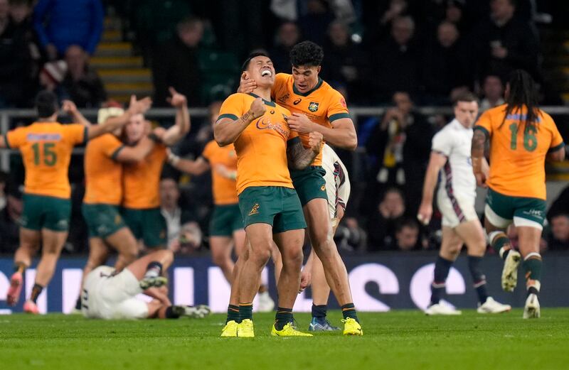 Australia's Len Ikitau (left) and Joseph Suaalii celebrate after team-mate Max Jorgensen (not pictured) scores a fourth try to snatch victory over England at the Allianz Stadium, Twickenham, London. Photograph: Andrew Matthews/PA