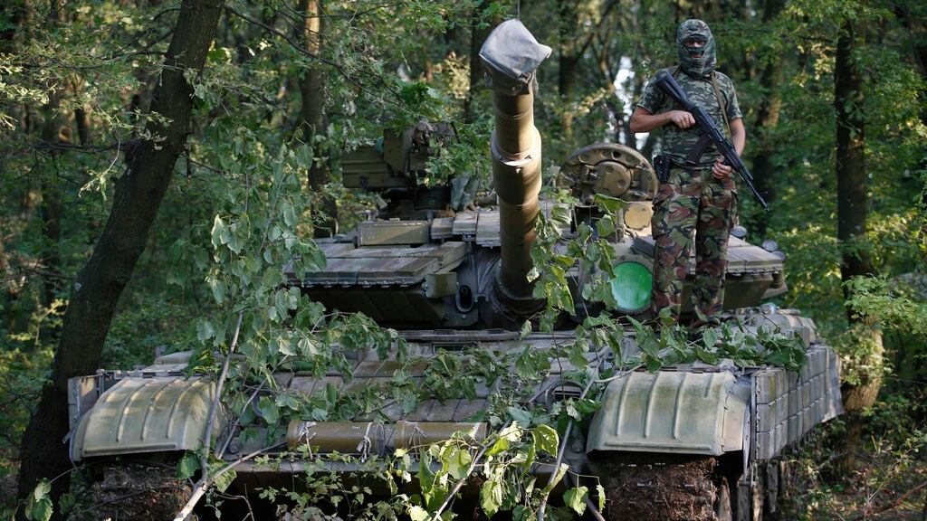 A pro-Russian separatist from the Vostok (east) battalion poses for a picture atop a T-64 tank in Donetsk. Photograph: Maxim Zmeyev/Reuters