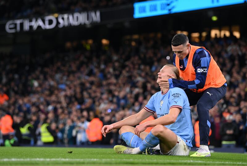 Manchester City striker Erling Harland celebrates with Phil Foden after scoring his record breaking 35th Premier League goal of the season. Photo: Stu Forster/Getty Images