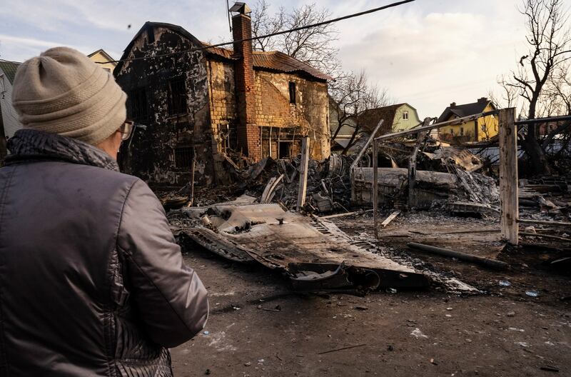A woman looks across debris from a downed aircraft in Kyiv on Friday. Photograph: Lynsey Addario/The New York