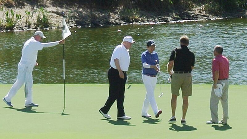 US president Donald Trump and Japan’s prime minister Shinzo Abe (centre) playing golf in Florida in February. Photograph: JIJI PRESS/AFP/Getty Images