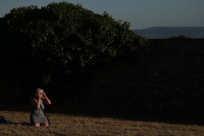 People wear eclipse glasses to watch the full solar eclipse at Dunsink Observatory. Photo: Clodagh Kilcoyne for The Irish Times