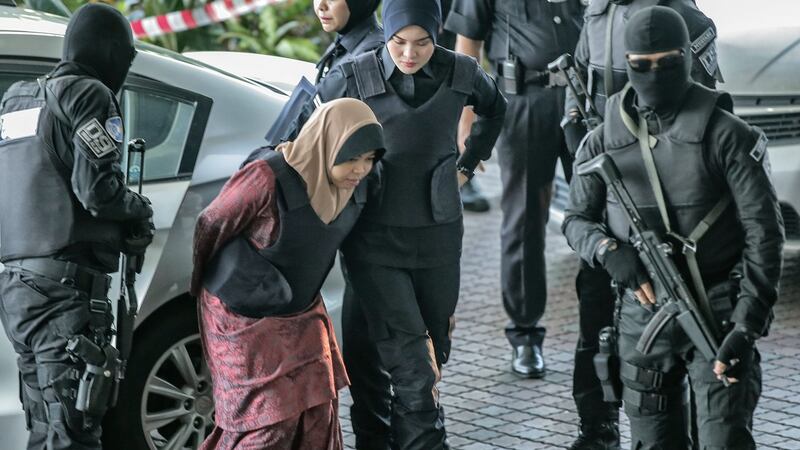 Siti Aisyah of Indonesia, who is being detained in connection with the death of Kim Jong-Nam, is escorted by Malaysian police officers as she arrives at the Shah Alam High Court, in Shah Alam, Malaysia, 27 February 2018.  Photograph: EPA/AHMAD YUSNI