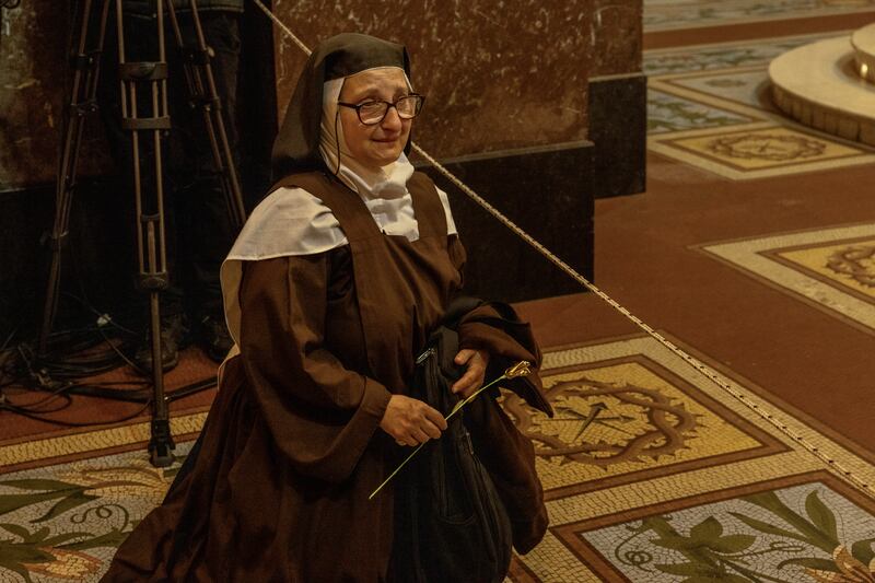 A nun sits on the floor as people gather to mourn Pope Francis at the Buenos Aires Metropolitan Cathedral in Buenos Aires, Argentina, on Monday.

Photograph: Sarah Pabst/The New York Times
                      