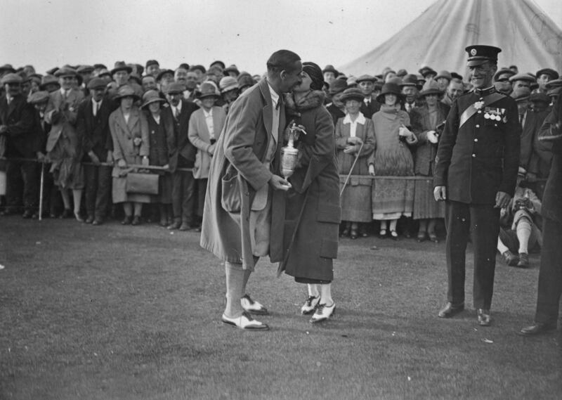 Walter Hagen of the USA, winner of the 1924 British Open at Hoylake, celebrating with his wife as he holds the Claret Jug. Photograph: Topical Press Agency/Getty Images