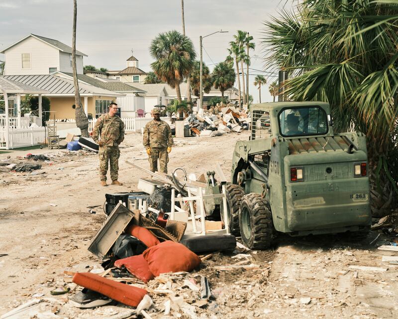 Members of the Florida National Guard clear debris from Hurricane Helene in St Pete Beach, Florida, as Hurricane Milton approaches. Photograph: Zack Wittman/The New York Times
                     