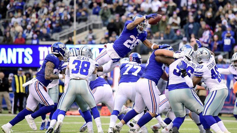 Saquon Barkley vaults into the endzone for a late touchdown. Photo: Steven Ryan/Getty Images