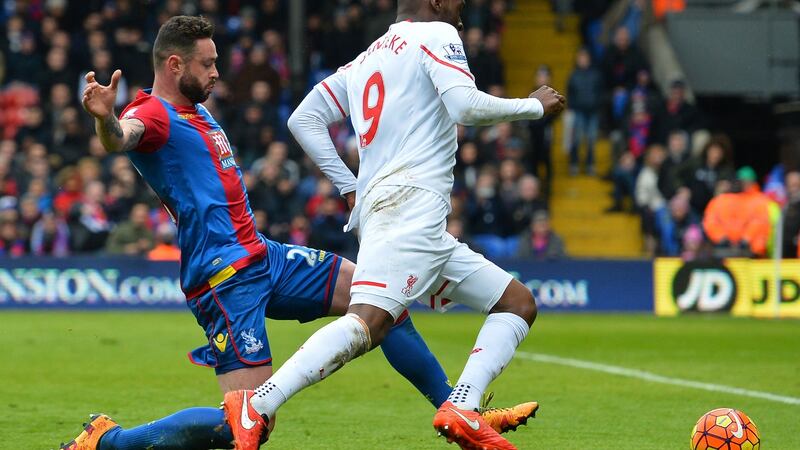 Crystal Palace’s Damien Delaney slides in on Christian Benteke of Liverpool, bringing him down and giving away the late penalty which saw the visitors win 2-1 in their Premier League clash. Photo: Glyn Kirk/Getty Images