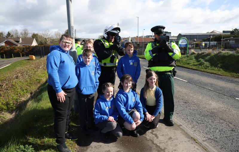 Pupils and PSNI officers operating speed detection devices outside Artigarvan Primary School. Photograph: Bryan O’Brien

